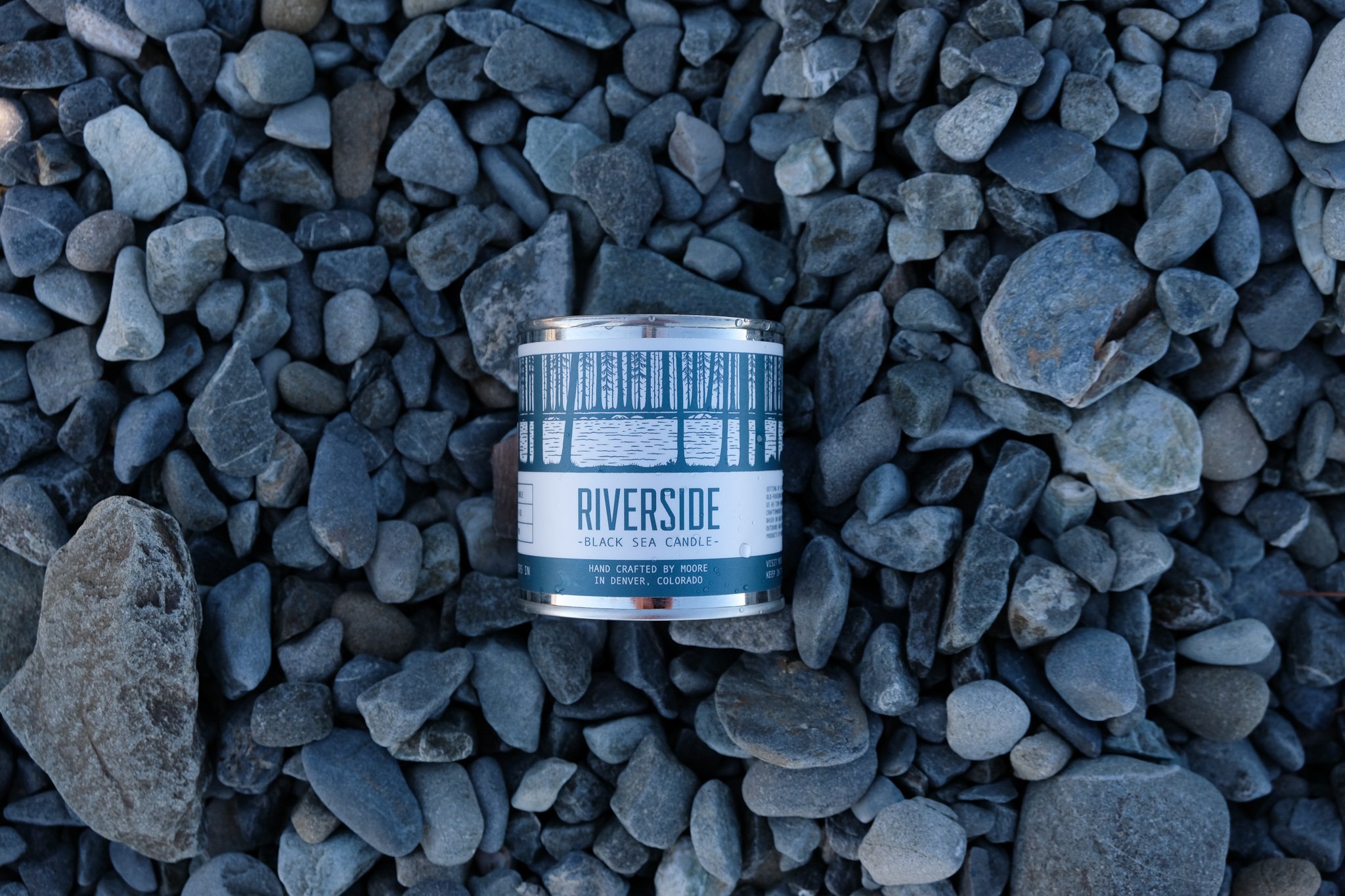 Riverside Candle in a serene setting, showcasing its natural soy wax and beautiful label design inspired by nature.