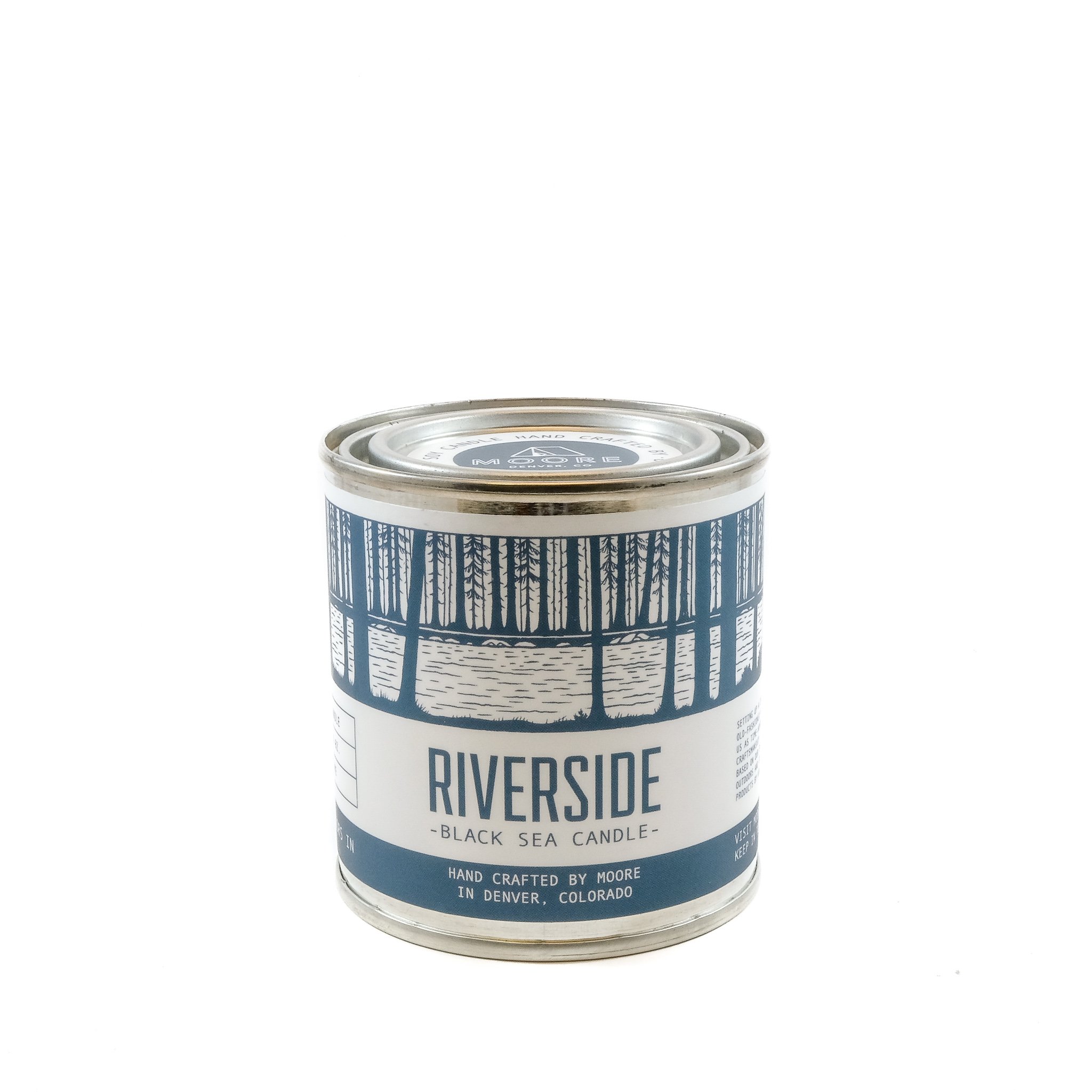 Riverside Candle in a serene setting, showcasing its natural soy wax and beautiful label design inspired by nature.