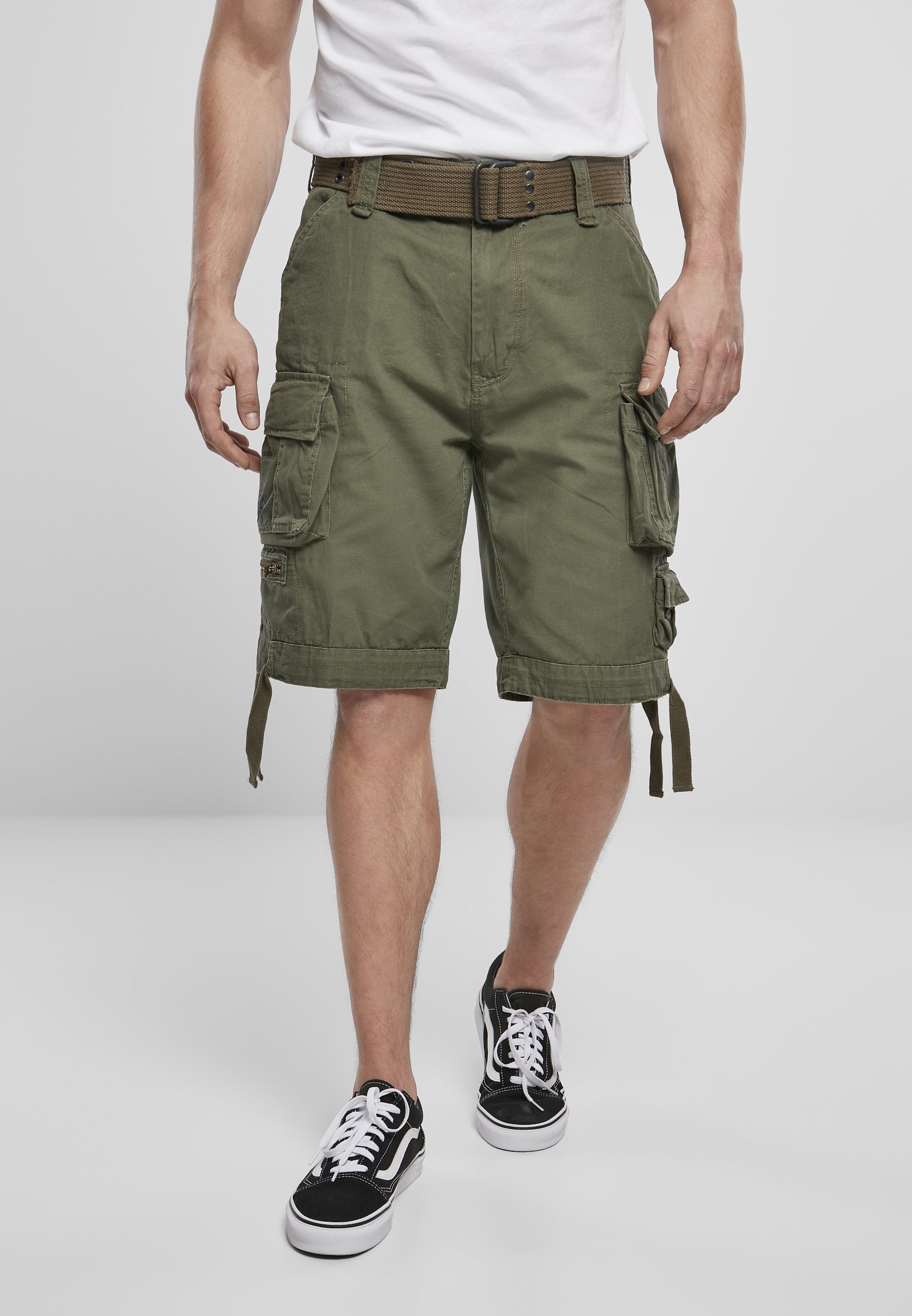 Savage Vintage Cargo Shorts in a rugged outdoor setting, showcasing large side pockets and decorative belt with eyelets.