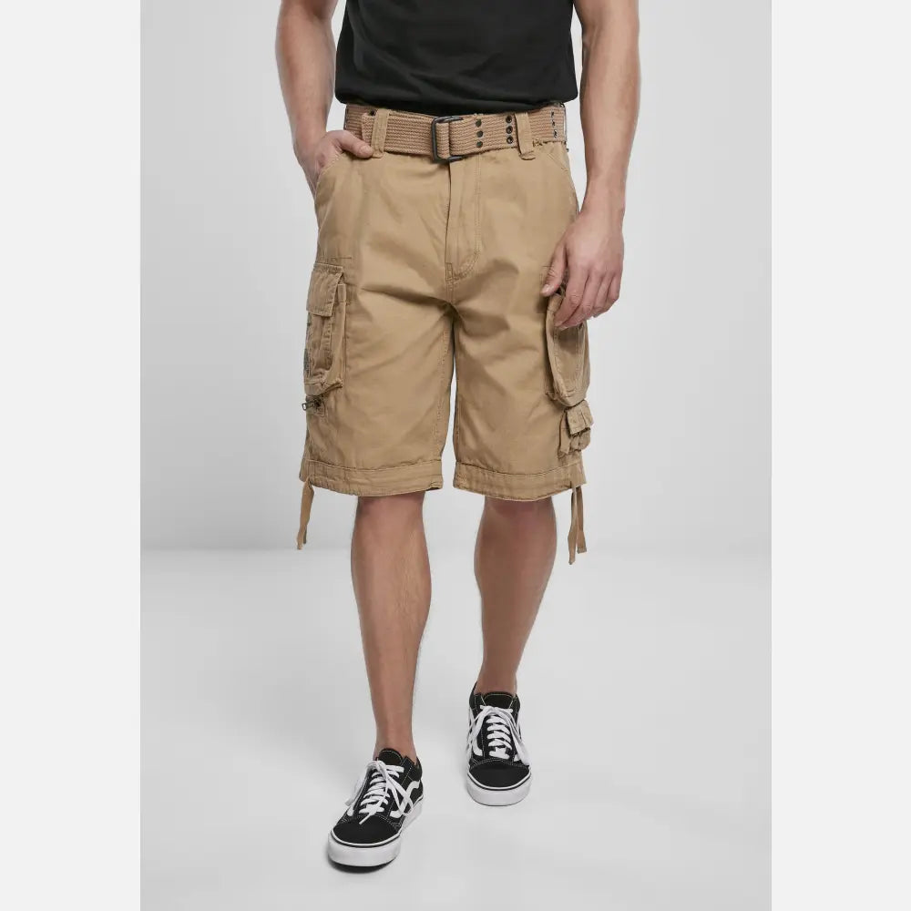 Savage Vintage Cargo Shorts in a rugged outdoor setting, showcasing large side pockets and decorative belt with eyelets.