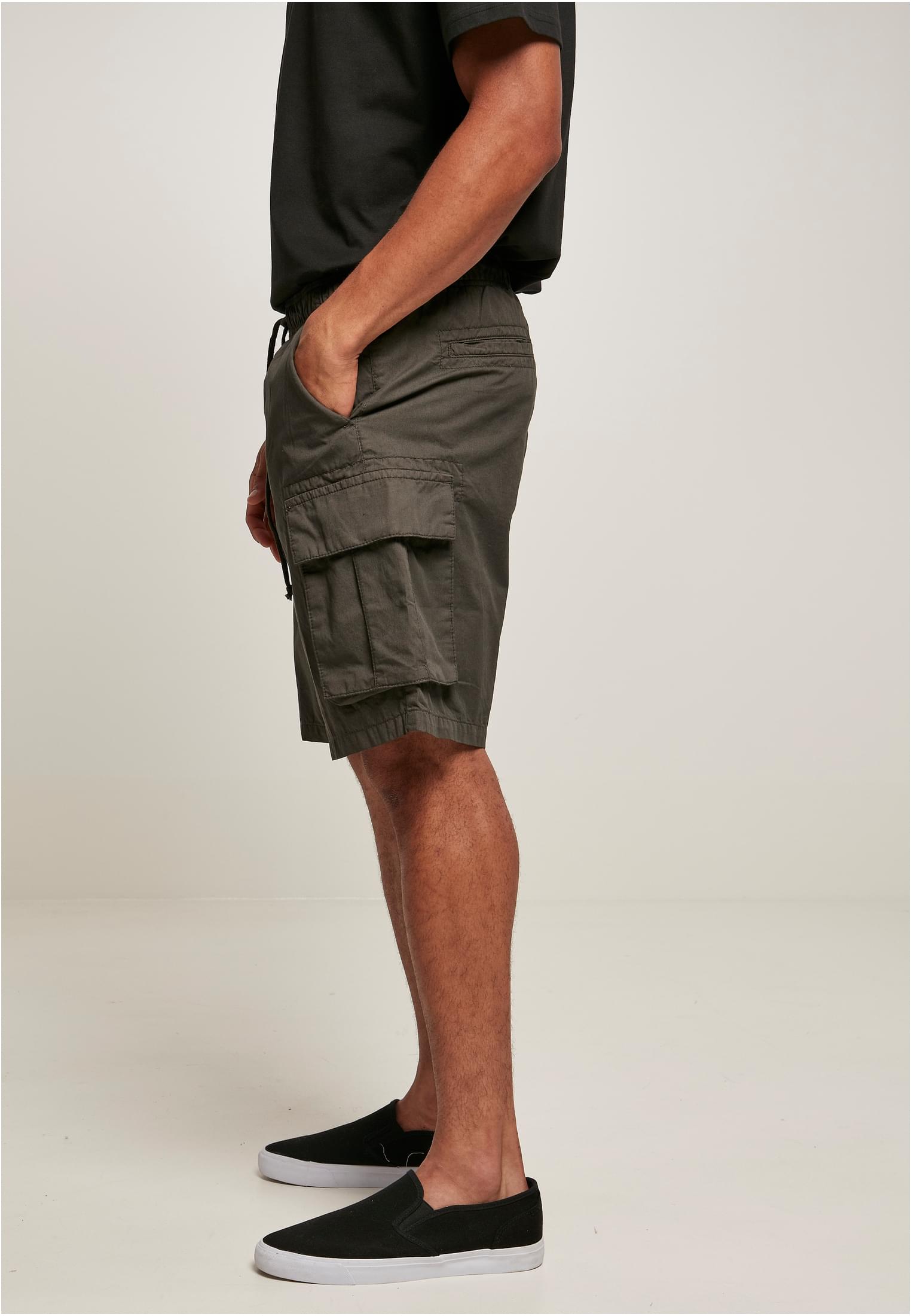 Men's short cargo shorts in cotton twill with six pockets, elastic waistband, and sporty design.