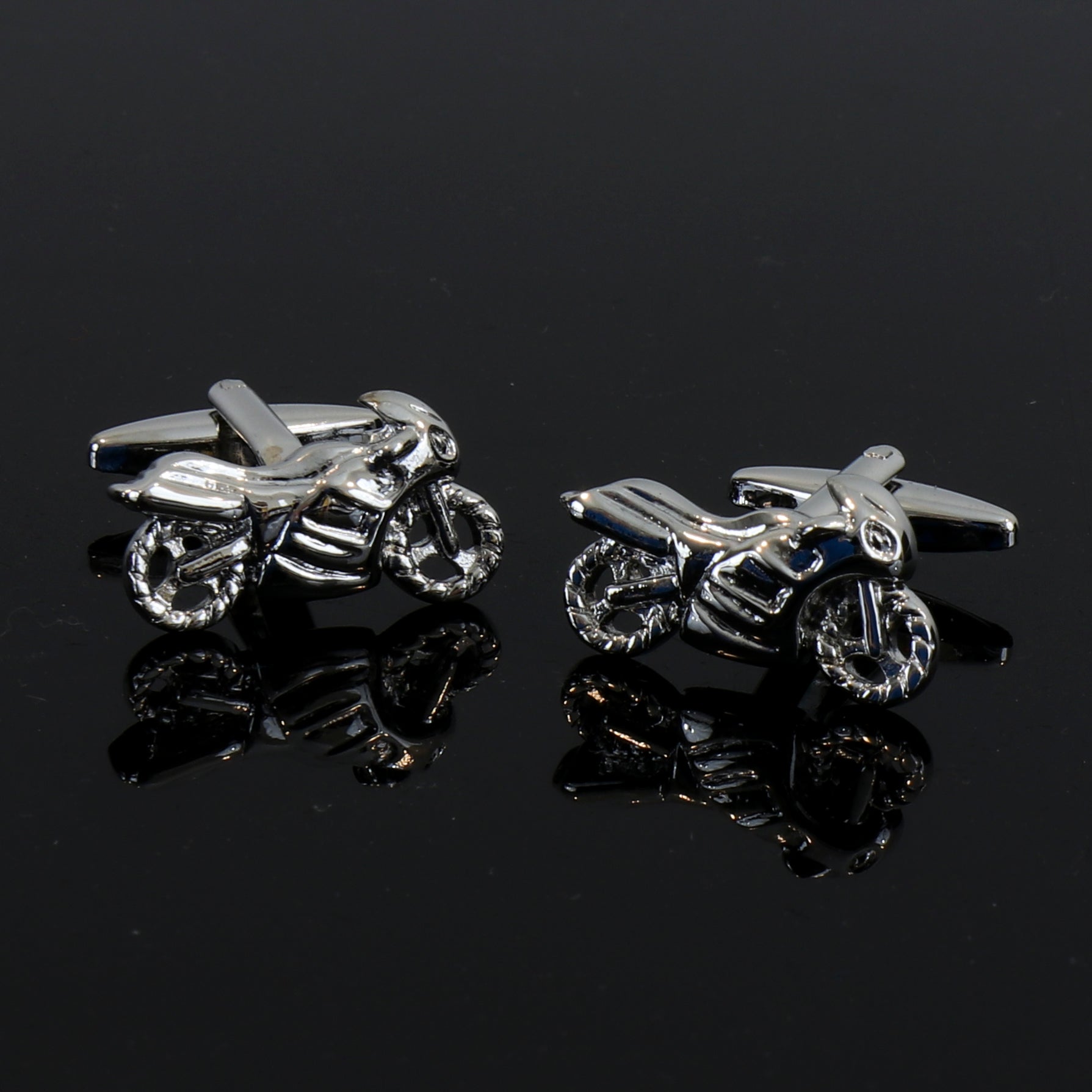 A pair of silver stainless steel motorbike cufflinks with dark blue stone triangle, elegantly displayed in a gift box.