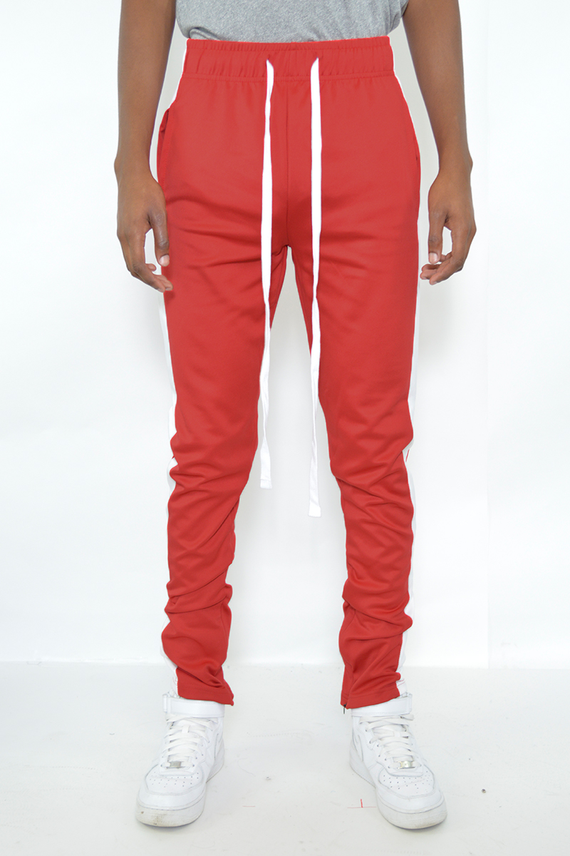 A pair of sleek slim fit track pants featuring a single stripe detail and hidden ankle zippers, perfect for athletic and casual wear.
