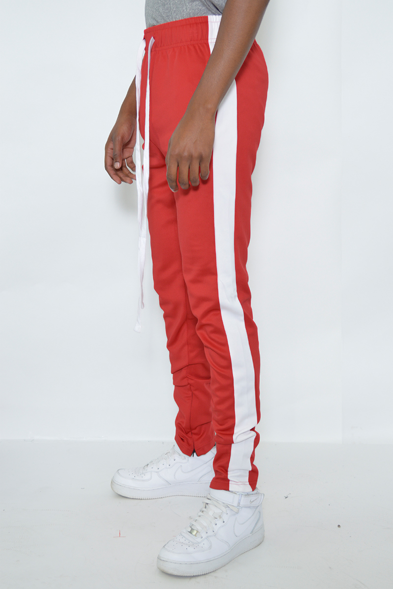 A pair of sleek slim fit track pants featuring a single stripe detail and hidden ankle zippers, perfect for athletic and casual wear.