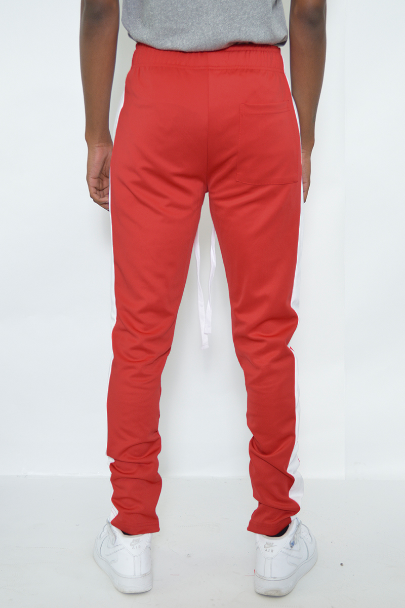 A pair of sleek slim fit track pants featuring a single stripe detail and hidden ankle zippers, perfect for athletic and casual wear.