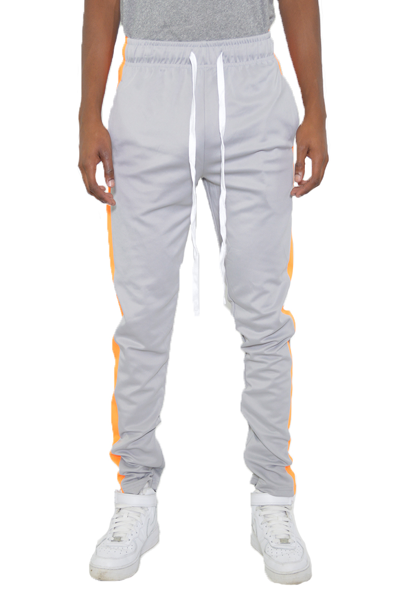 A pair of stylish slim fit track pants featuring a single stripe detail and hidden ankle zippers, perfect for workouts and casual wear.