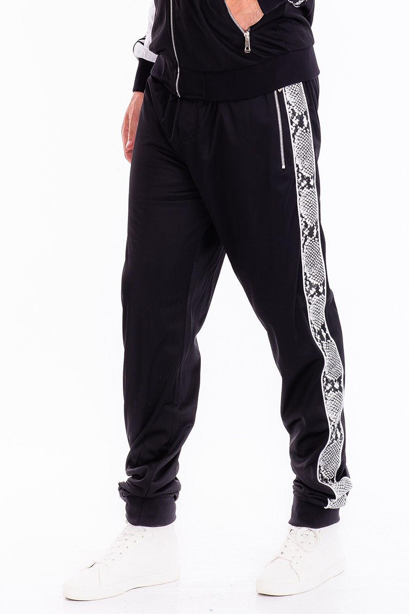 A pair of stylish SNAKE SIDE TRACK PANTS featuring an elastic waist, ankle zippers, and zippered back pockets, perfect for casual and active wear.