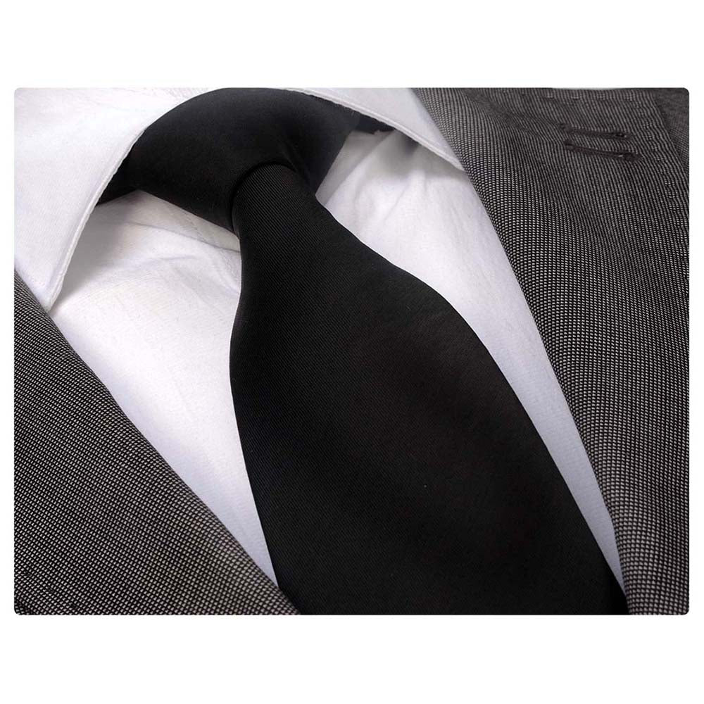 Solid black designer silk necktie elegantly displayed in a gift box, showcasing premium quality and craftsmanship.