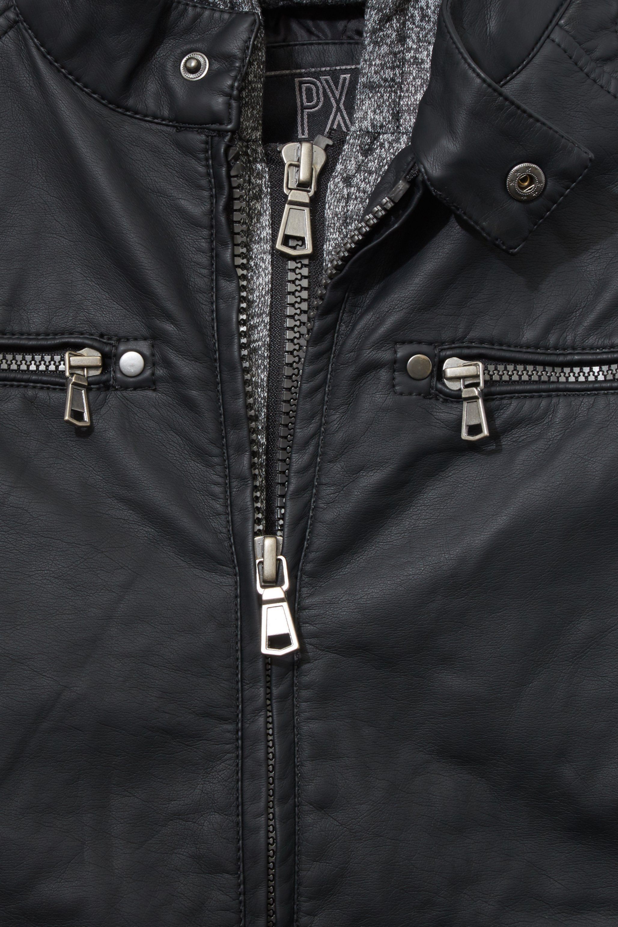 Vegan leather moto jacket with a knit hoodie, showcasing its stylish design and cozy features.