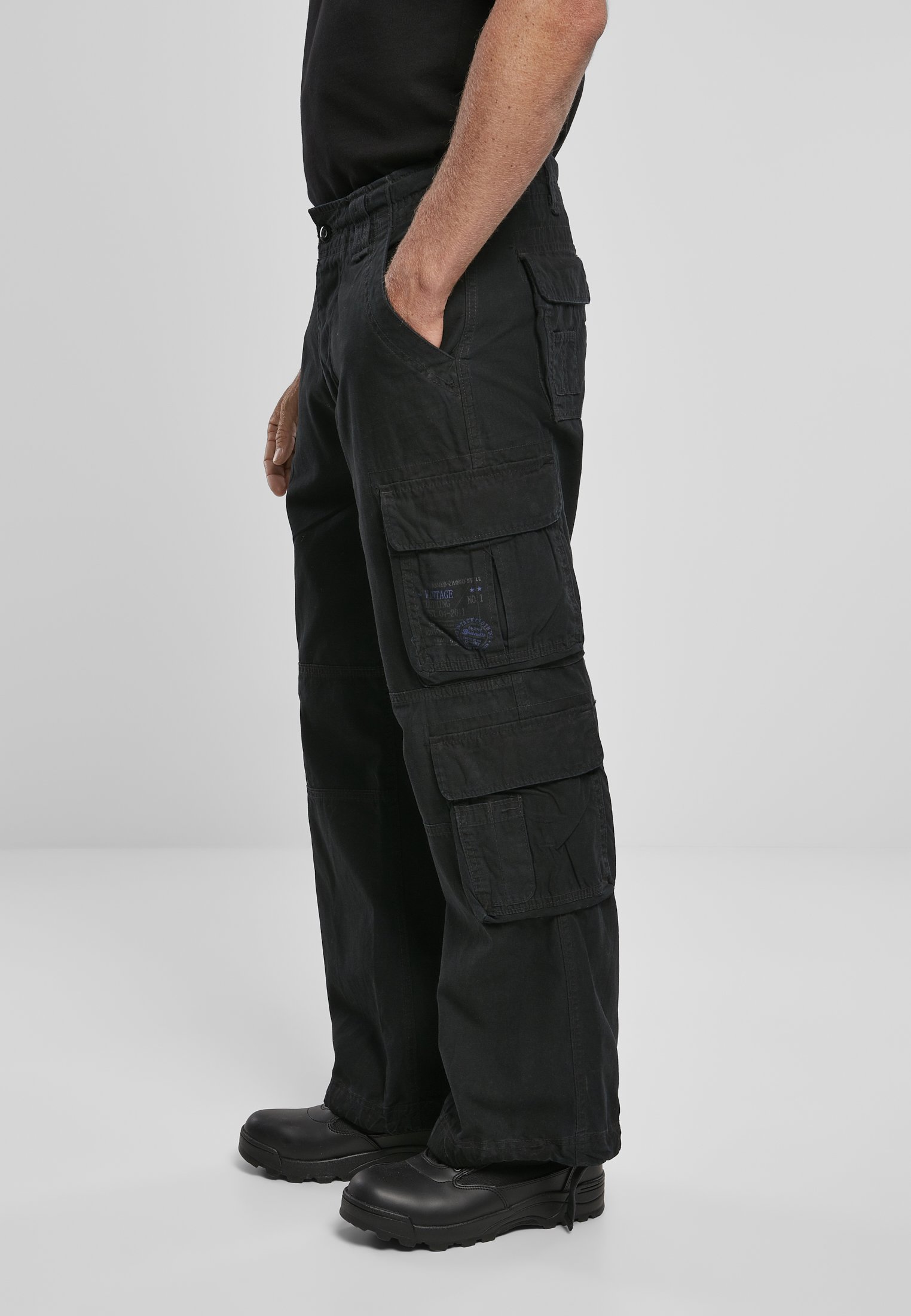 A pair of Vintage Cargo Pants in various colors, featuring spacious side pockets and adjustable drawstrings at the leg ends.
