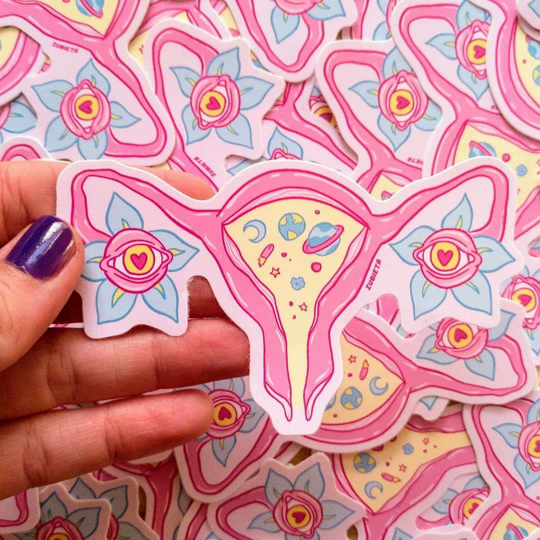 A vibrant Cosmic Uterus Sticker featuring intricate designs, perfect for personalizing laptops, notebooks, and cars.