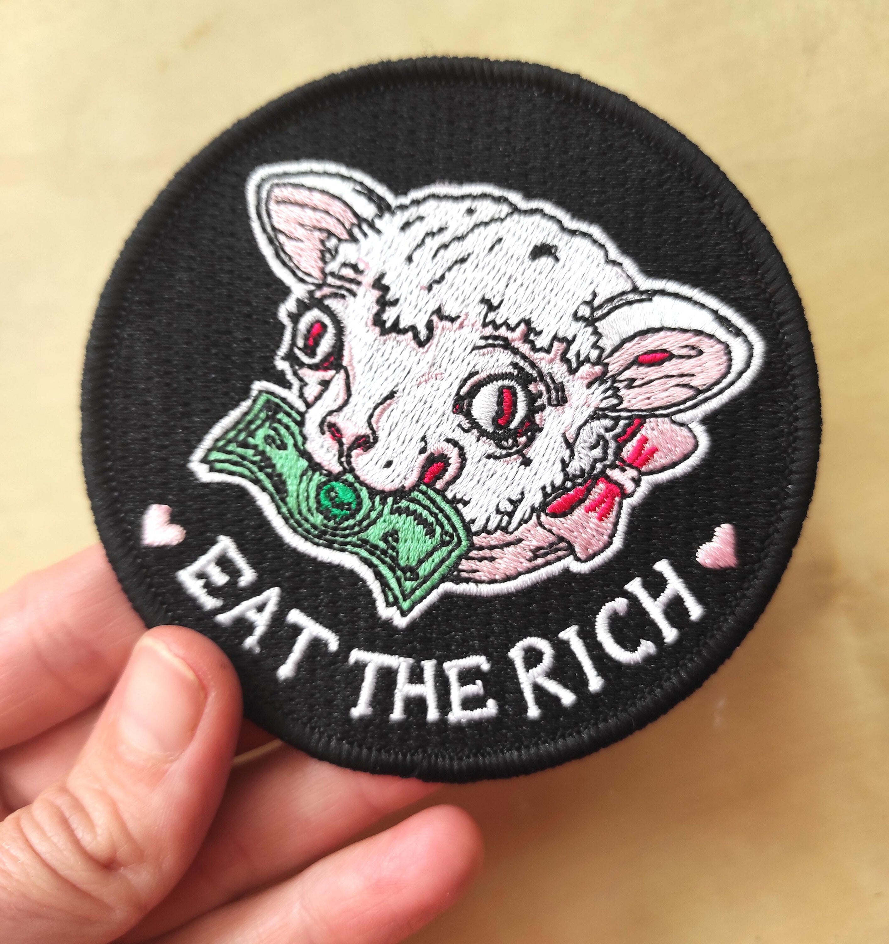 Eat the Rich Embroidered Patch featuring a Rousseau-inspired design in six vibrant colors, measuring 10cm x 10cm.