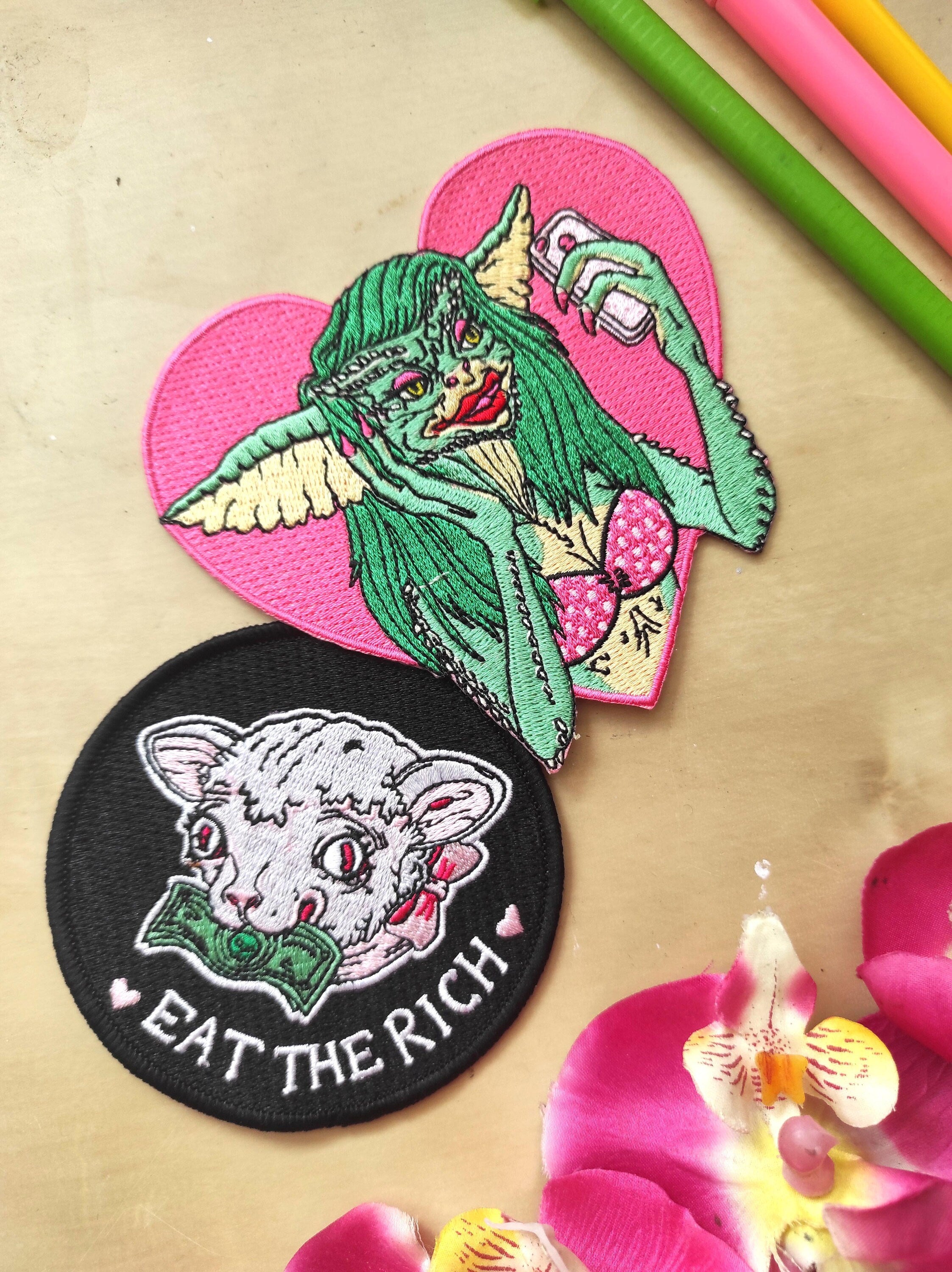 Eat the Rich Embroidered Patch featuring a Rousseau-inspired design in six vibrant colors, measuring 10cm x 10cm.