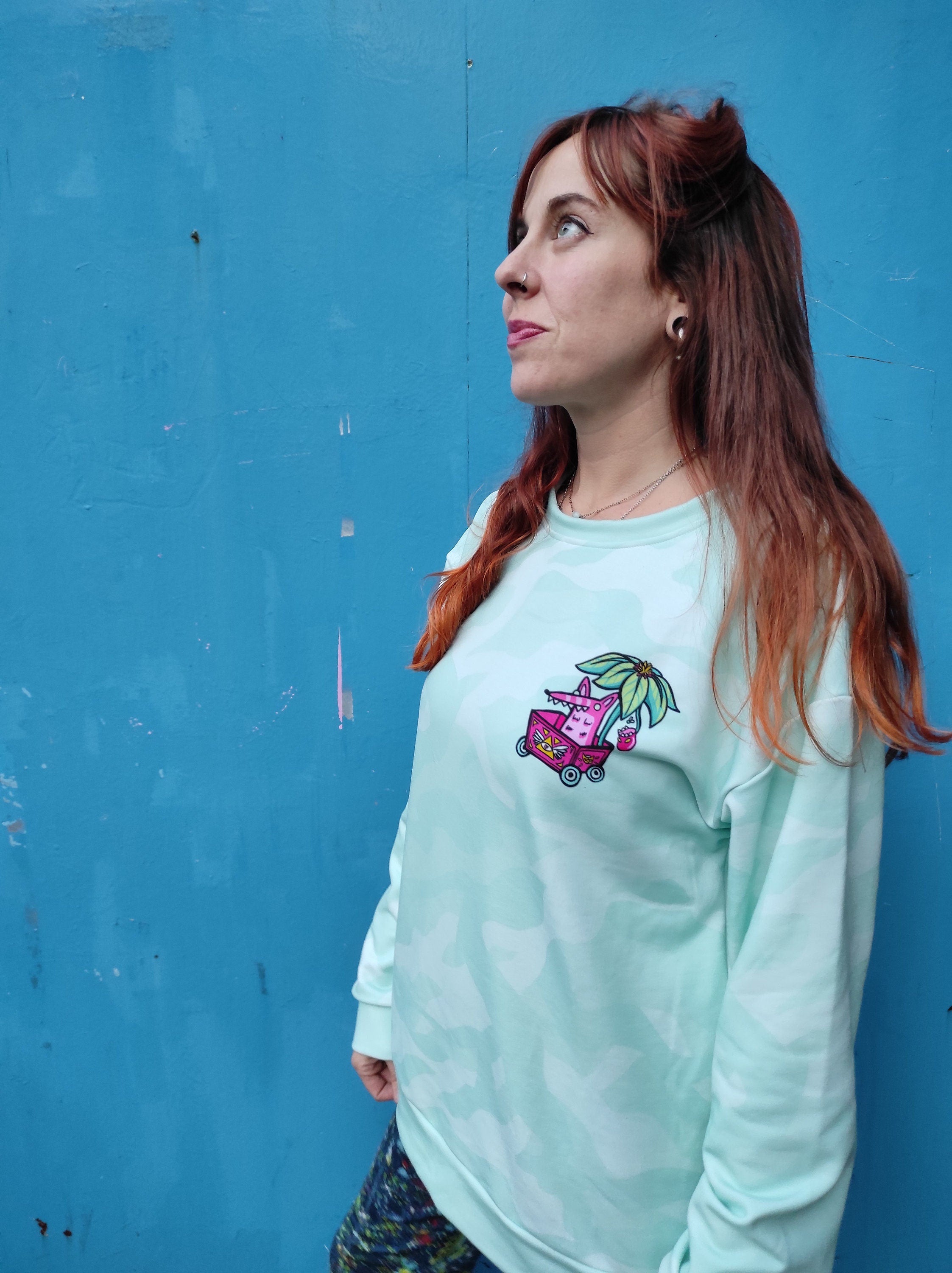 A vibrant sweatshirt featuring a psychedelic design inspired by Bill Hicks' quote about life, showcasing its soft brushed fleece interior.