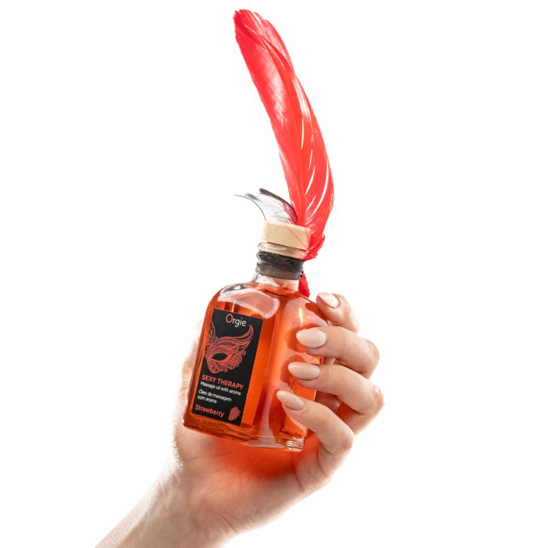 Orgie Sexy Therapy Massage Kit Strawberry 100ml, featuring a sleek bottle with a vibrant strawberry design, ideal for sensual massages.