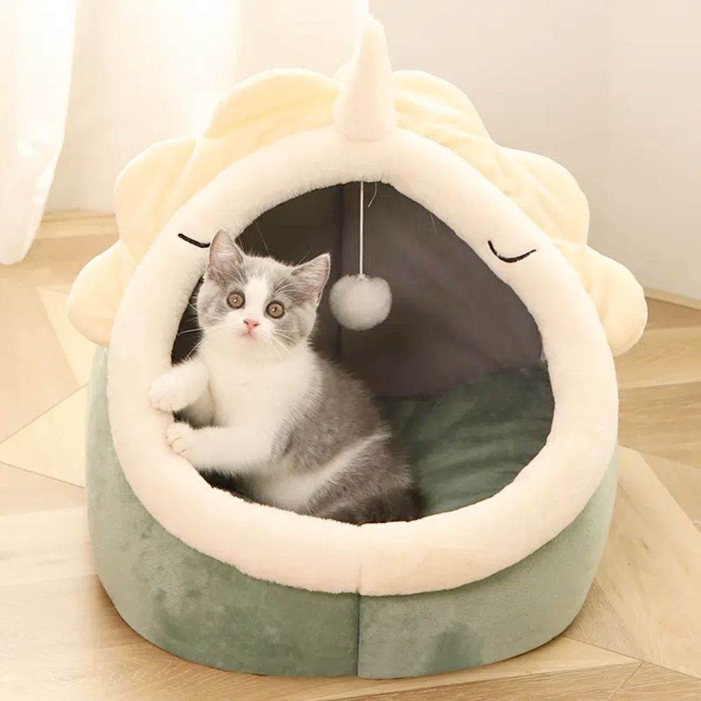 Adorable Dinosaur Pet House featuring a soft padded bed and a dangling toy ball, perfect for cats and dogs.