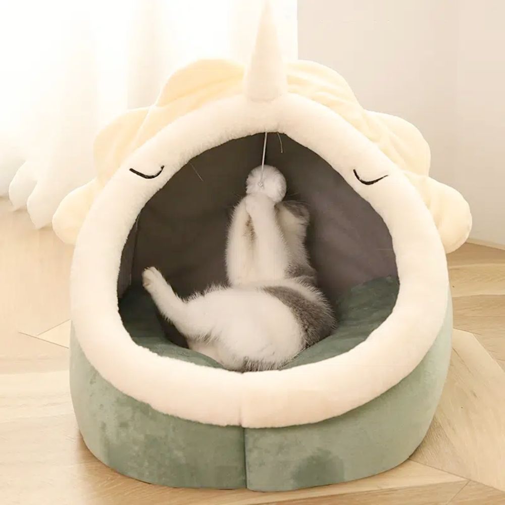 Adorable Dinosaur Pet House featuring a soft padded bed and a dangling toy ball, perfect for cats and dogs.