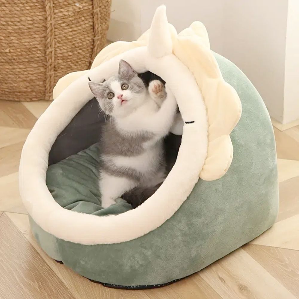 Adorable Dinosaur Pet House featuring a soft padded bed and a dangling toy ball, perfect for cats and dogs.