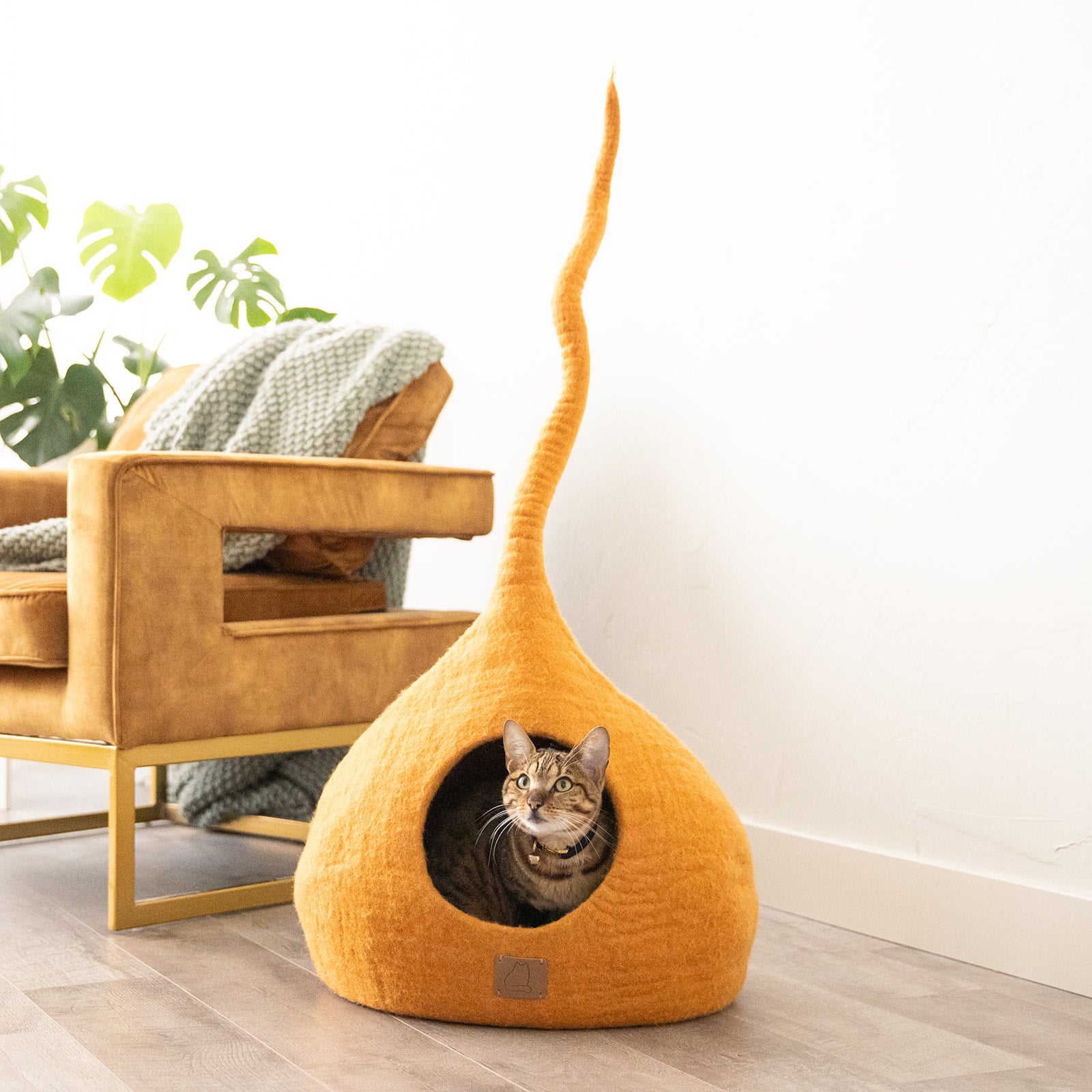 Fire Orange Tail Style Cave, a modern cat cave made of felted wool, featuring a peekaboo entrance and vibrant color, perfect for stylish pet owners.