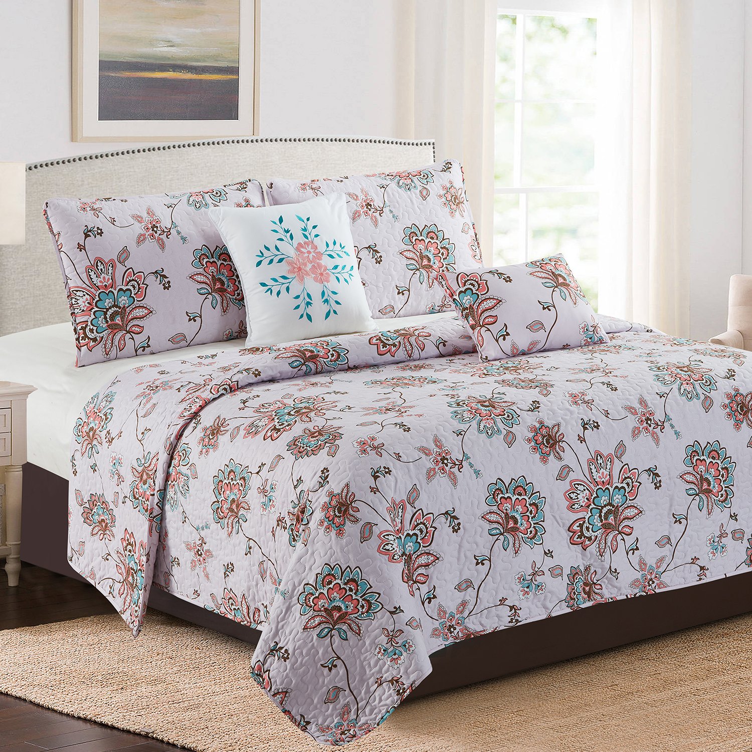 Karina 5 Piece Quilt Set in Royal Blue Medallion, featuring a quilt, two pillow shams, a square cushion, and a rectangle cushion, elegantly displayed on a bed.