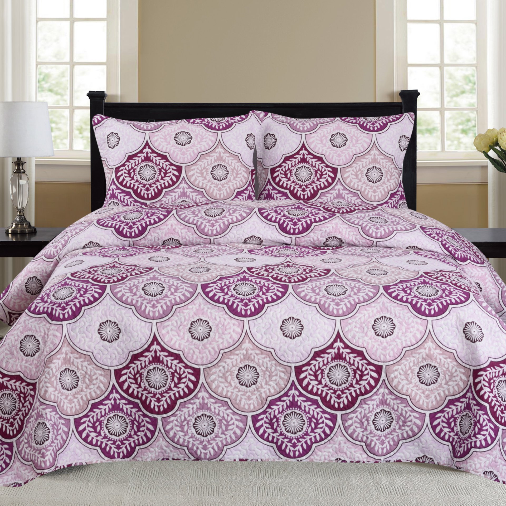 Nikki 3 Piece Quilt Set in Purple, featuring a quilt and two matching pillow shams, elegantly displayed on a bed.