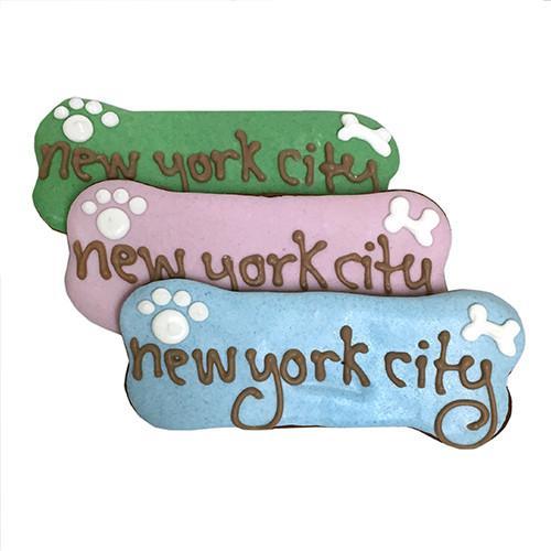 A pack of Custom Bones dog treats, personalized with text, featuring a yogurt coating and colorful vegetable coloring, perfect for dogs.