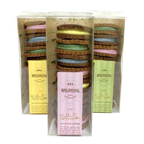 A beautifully arranged box of assorted macarons featuring peanut butter and carob flavors, perfect for gifting or sharing.