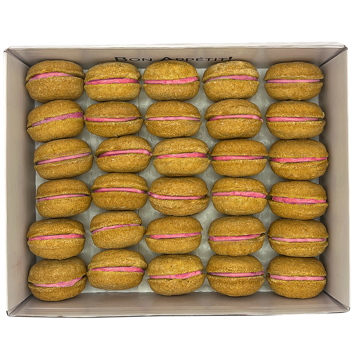 A colorful assortment of 40 dog macarons in a non-branded plastic tube, showcasing their appealing design and natural ingredients.