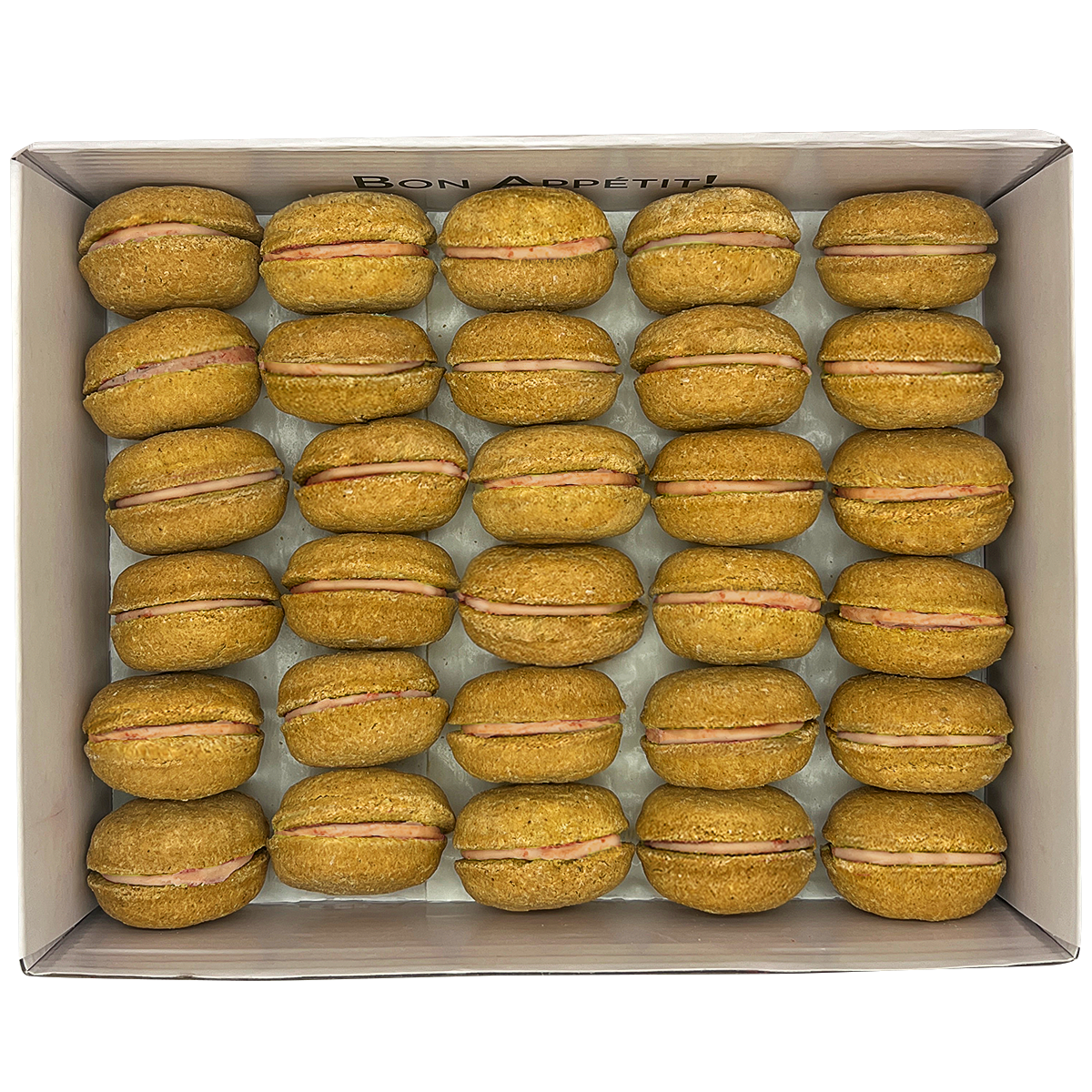 A colorful assortment of 40 dog macarons in a non-branded plastic tube, showcasing their appealing design and natural ingredients.