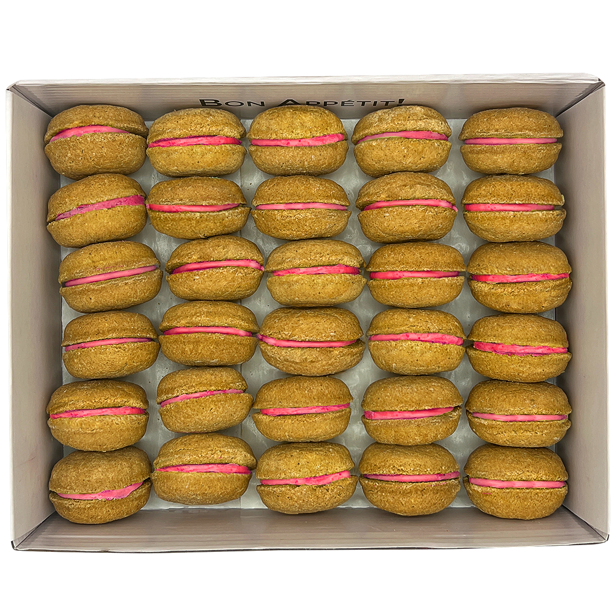 A colorful assortment of 40 dog macarons in a non-branded plastic tube, showcasing their appealing design and natural ingredients.