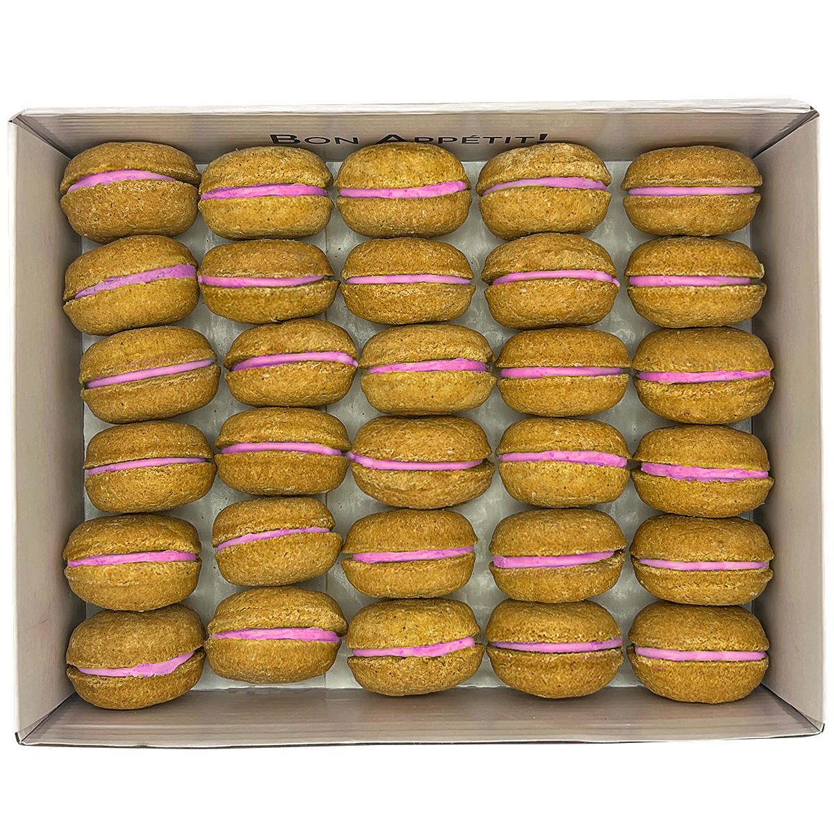 A colorful assortment of 40 dog macarons in a non-branded plastic tube, showcasing their appealing design and natural ingredients.