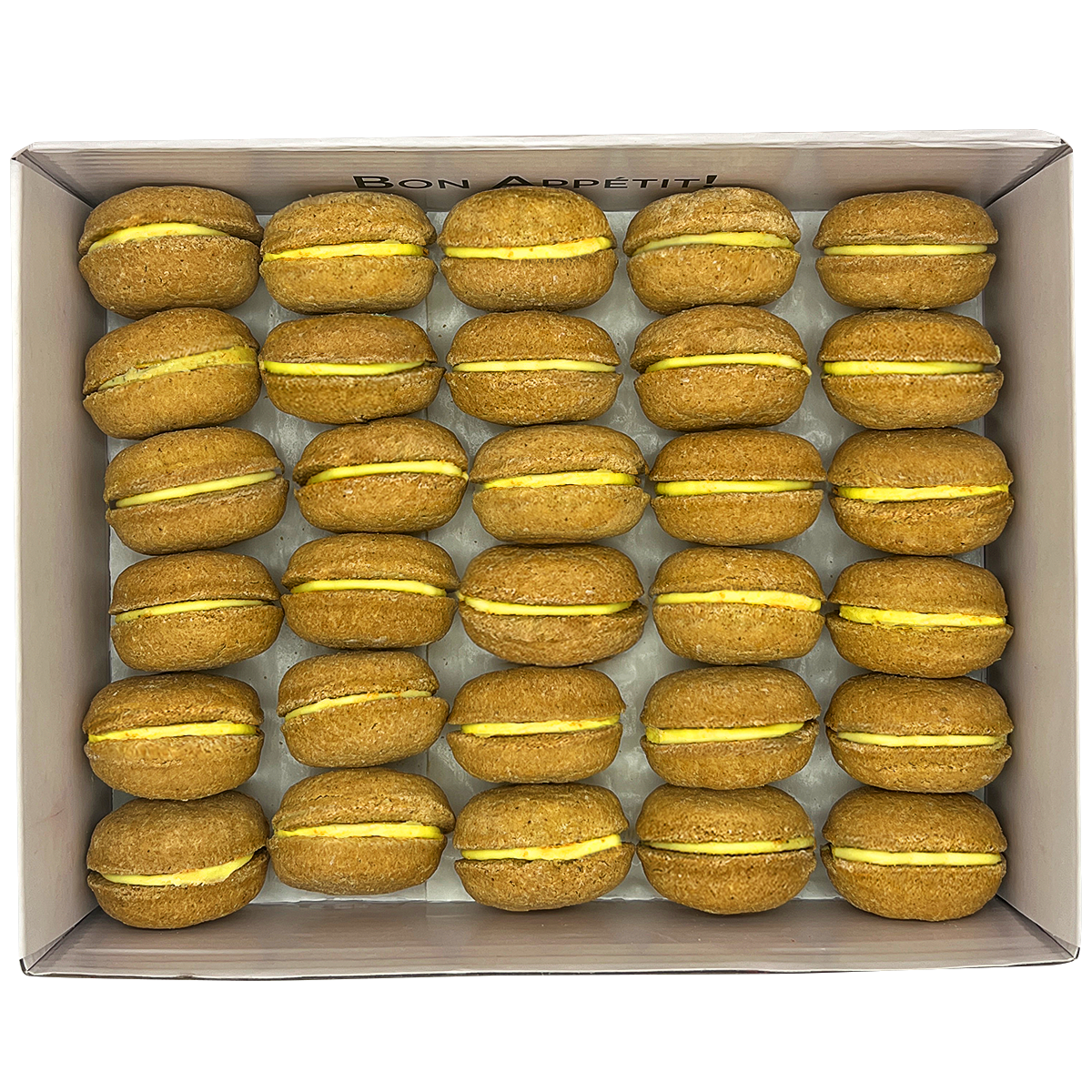 A colorful assortment of 40 dog macarons in a non-branded plastic tube, showcasing their appealing design and natural ingredients.
