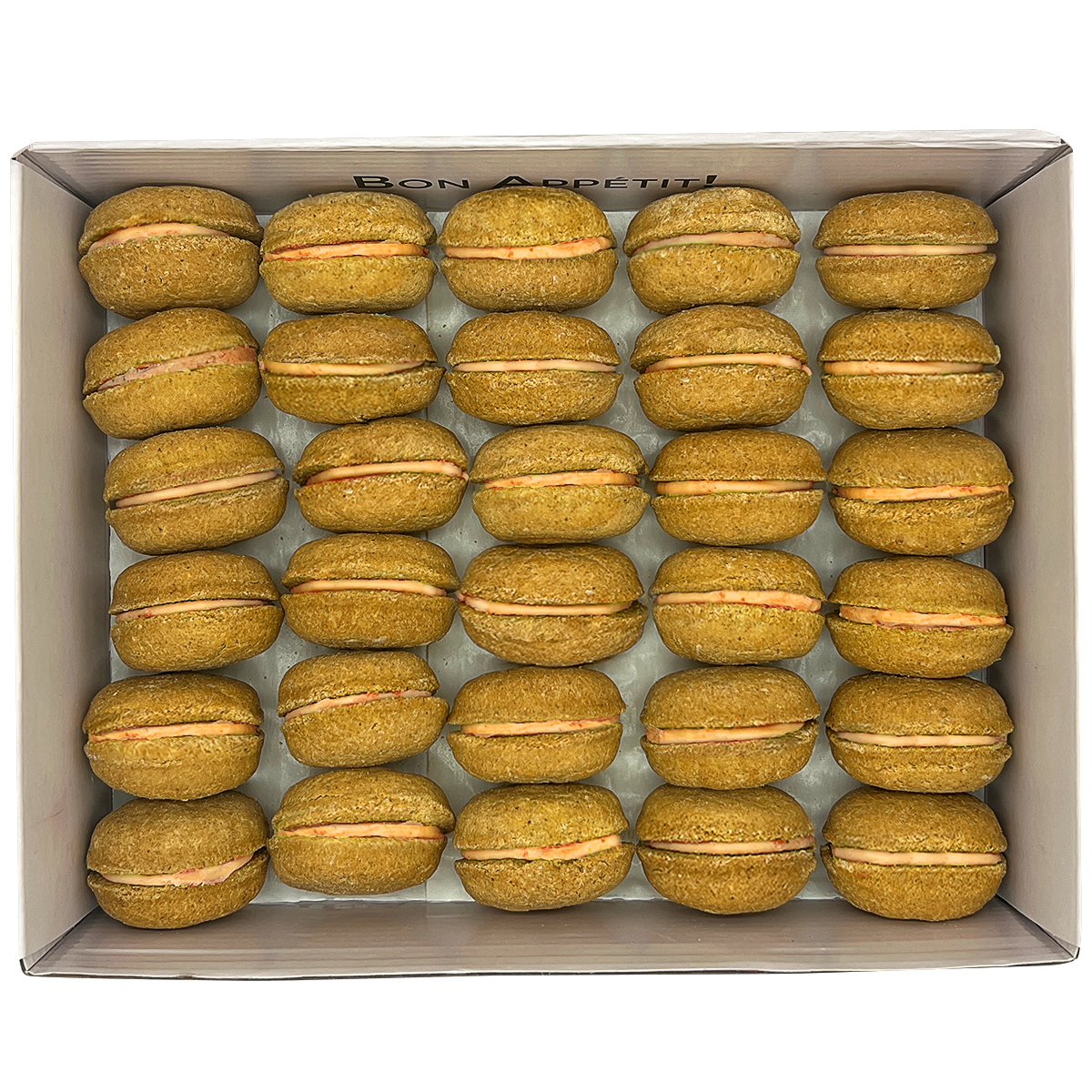 A colorful assortment of 40 dog macarons in a non-branded plastic tube, showcasing their appealing design and natural ingredients.