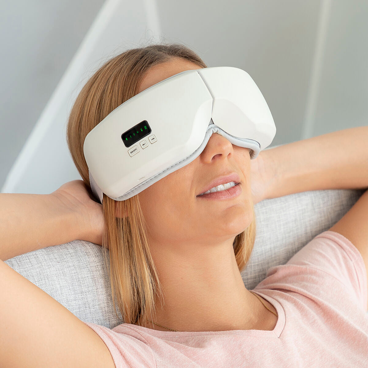 4-In-1 Eye Massager with Air Compression, featuring ergonomic design, heat function, and Bluetooth connectivity for relaxation.