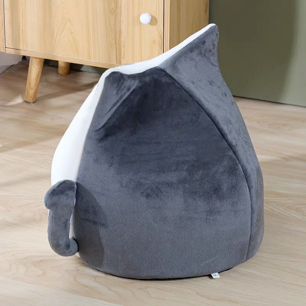 Adorable cat-shaped pet house with soft padded bed, perfect for small pets.