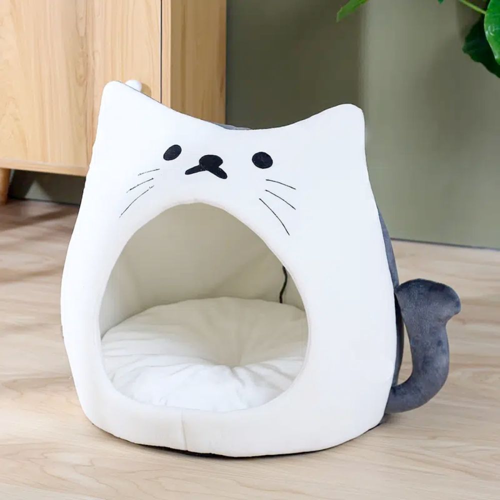 Adorable cat-shaped pet house with soft padded bed, perfect for small pets.