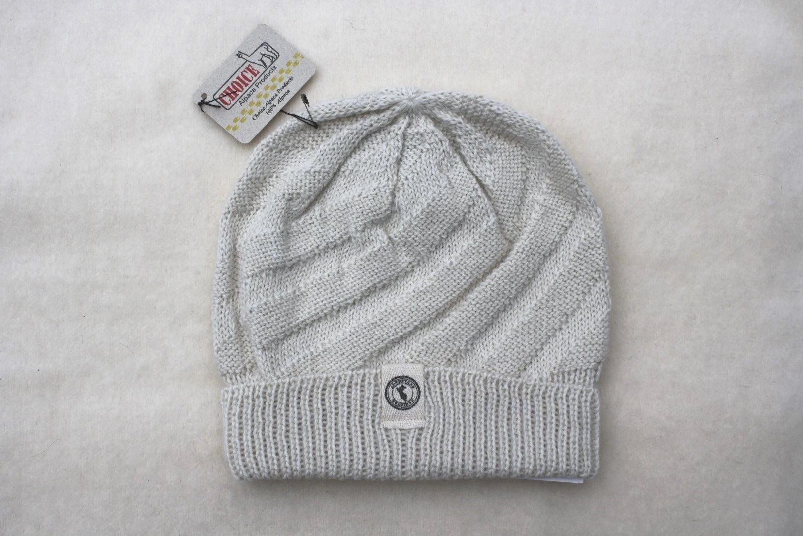 Kingsley Alpaca Hat made from 100% baby alpaca wool, hand-knit by Quechua artisans in Peru, featuring a stylish design for warmth and comfort.