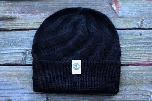 Kingsley Alpaca Hat made from 100% baby alpaca wool, hand-knit by Quechua artisans in Peru, featuring a stylish design for warmth and comfort.