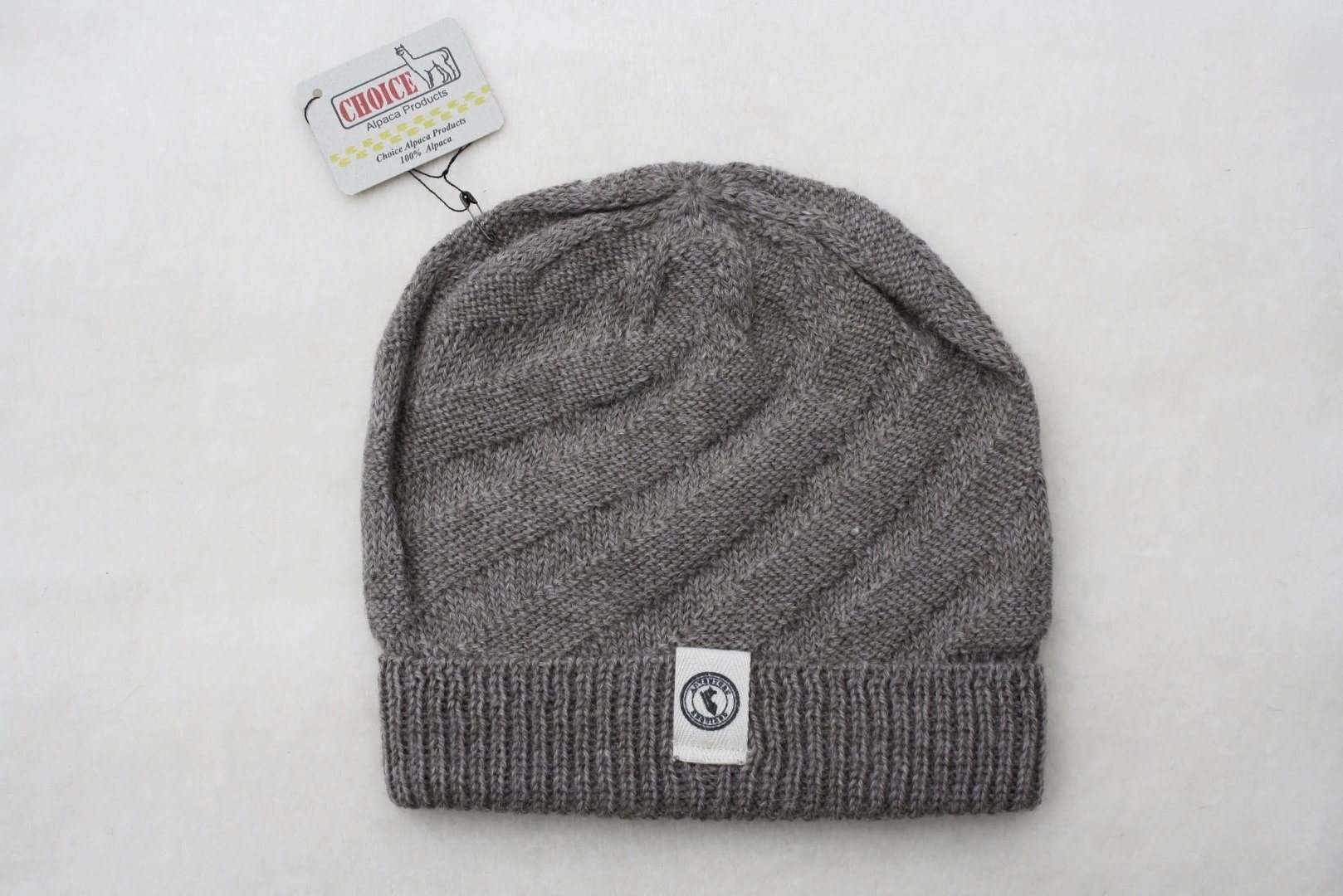 Kingsley Alpaca Hat made from 100% baby alpaca wool, hand-knit by Quechua artisans in Peru, featuring a stylish design for warmth and comfort.