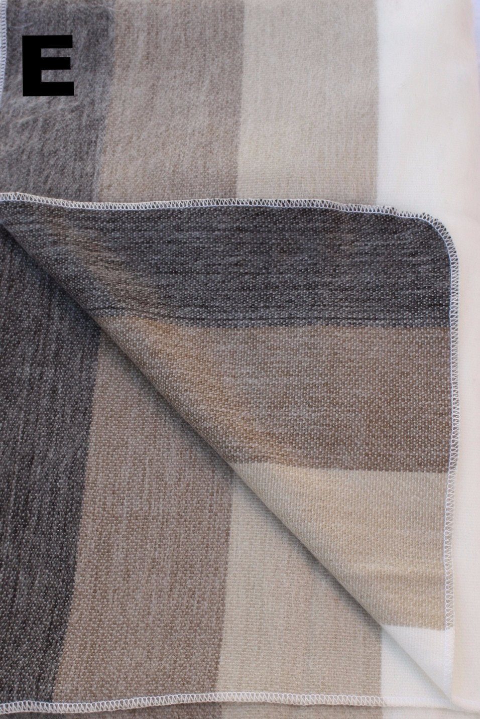 Luxurious Alpaca at Home Alpaca Throw featuring a brushed striped design, perfect for cozying up at home or on the go.