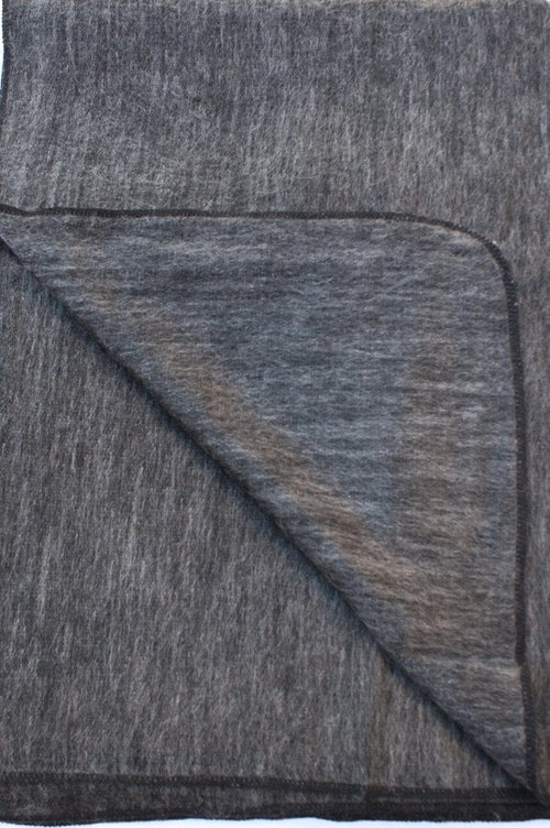 Luxurious Alpaca at Home Alpaca Throw featuring a brushed striped design, perfect for cozying up at home or on the go.