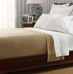 Luxurious alpaca bed blanket in various colors, showcasing its soft texture and oversized design, perfect for cozy nights.