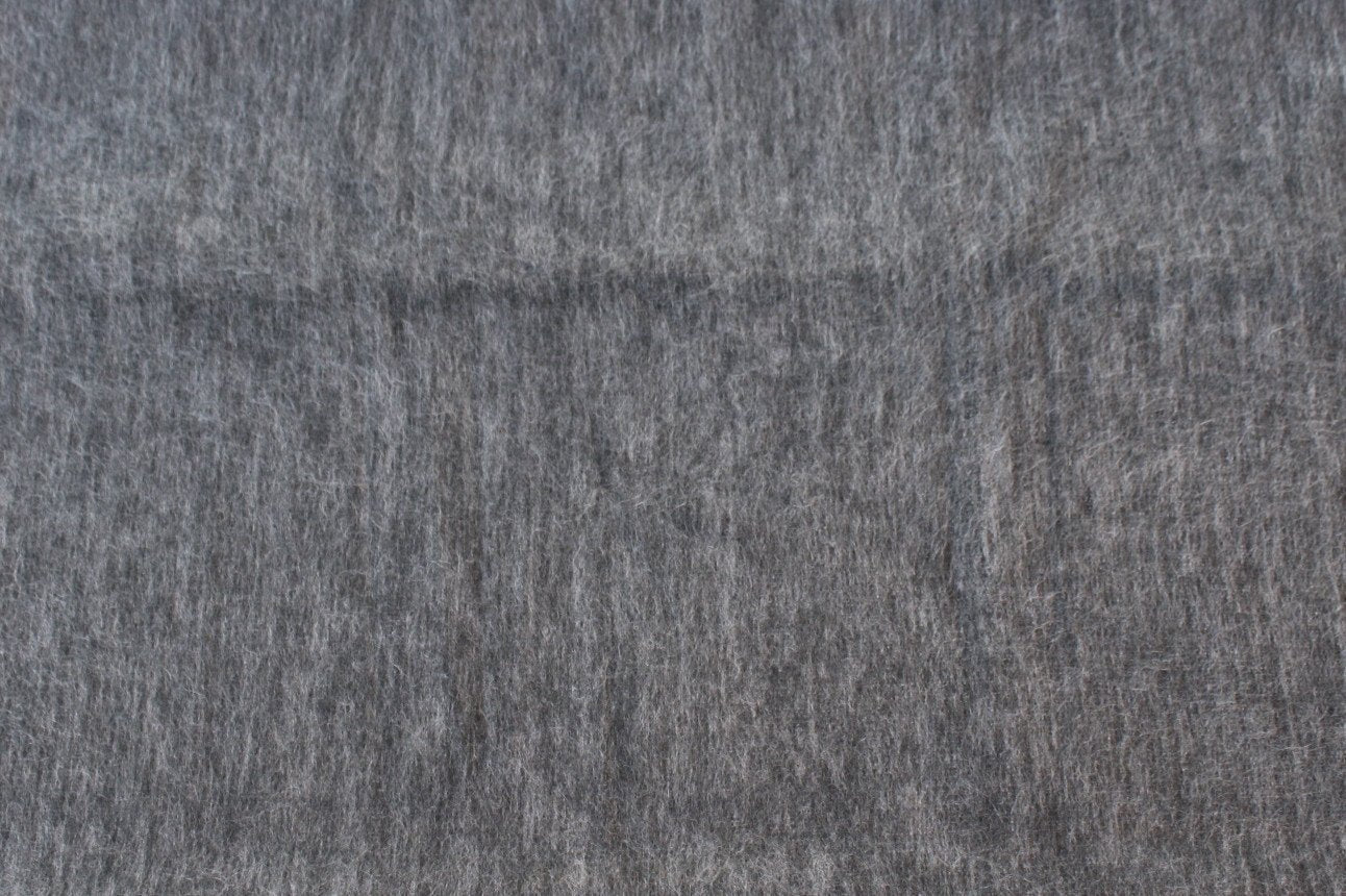 Luxurious alpaca bed blanket in various colors, showcasing its soft texture and oversized design, perfect for cozy nights.