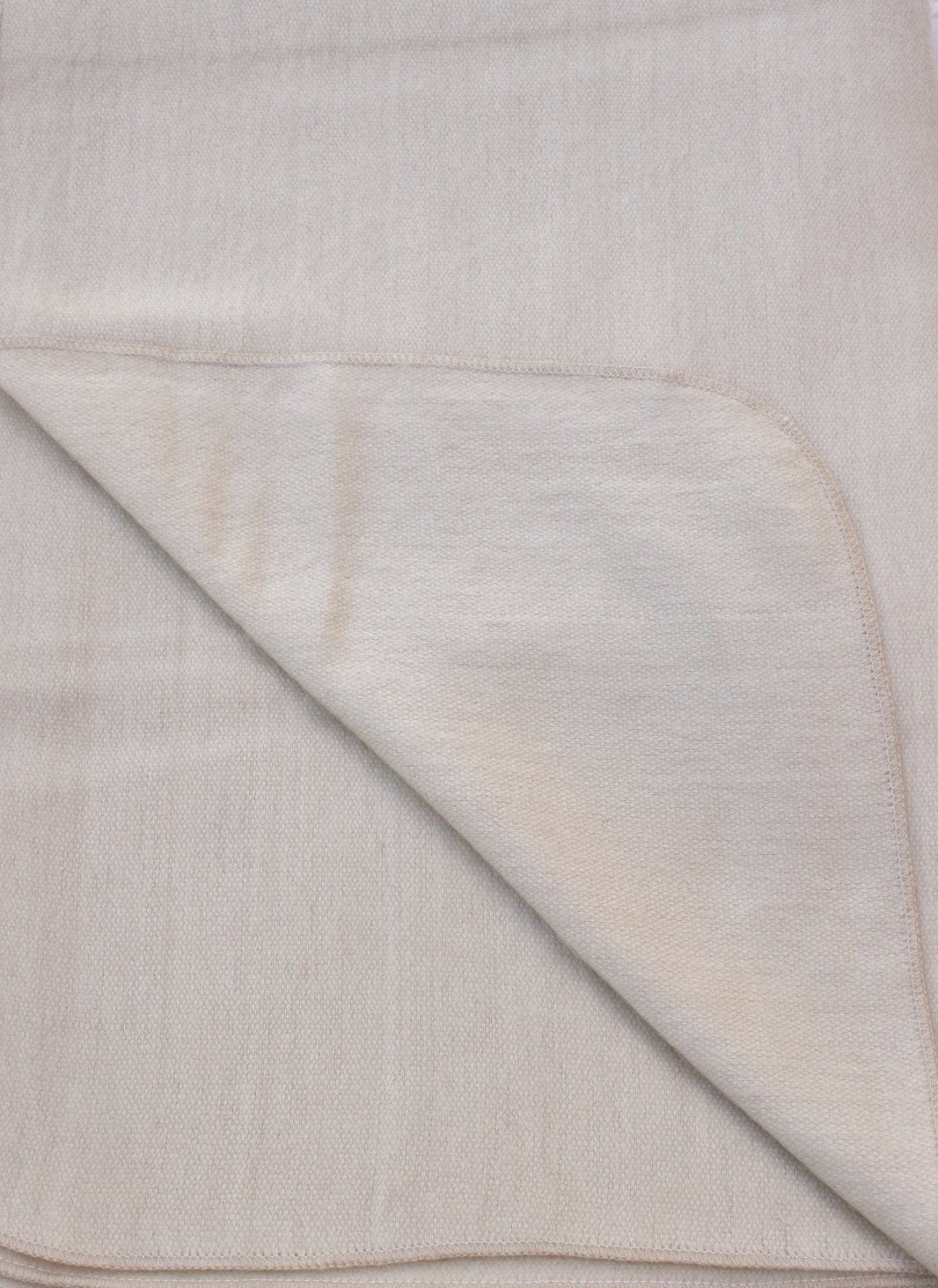 Luxurious alpaca bed blanket in various colors, showcasing its soft texture and oversized design, perfect for cozy nights.