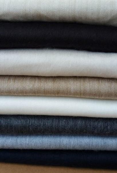 Luxurious alpaca bed blanket in various colors, showcasing its soft texture and oversized design, perfect for cozy nights.