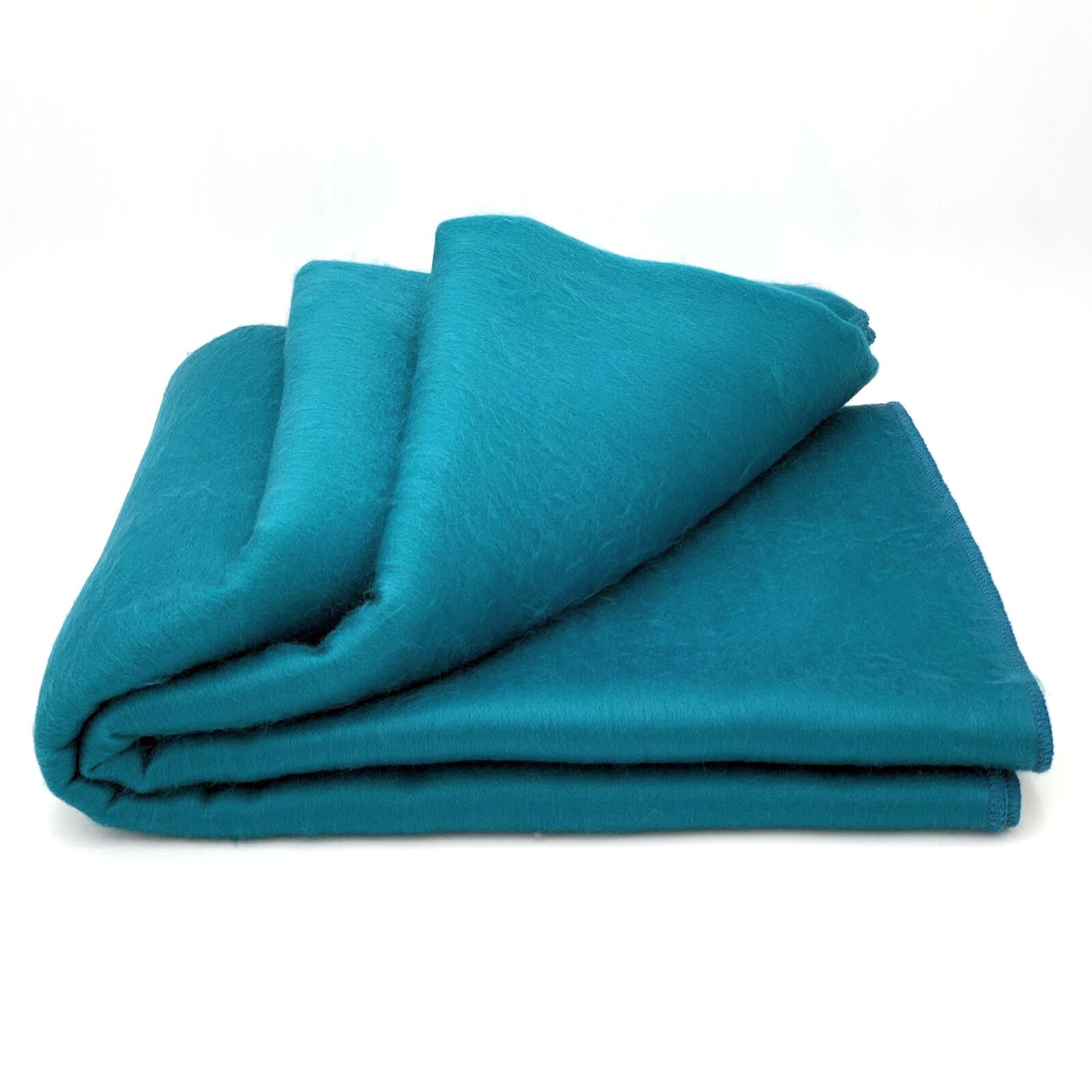 Luxurious alpaca bed blanket in various colors, showcasing its soft texture and oversized design, perfect for cozy nights.