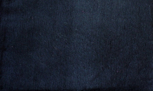 Luxurious alpaca bed blanket in various colors, showcasing its soft texture and oversized design, perfect for cozy nights.