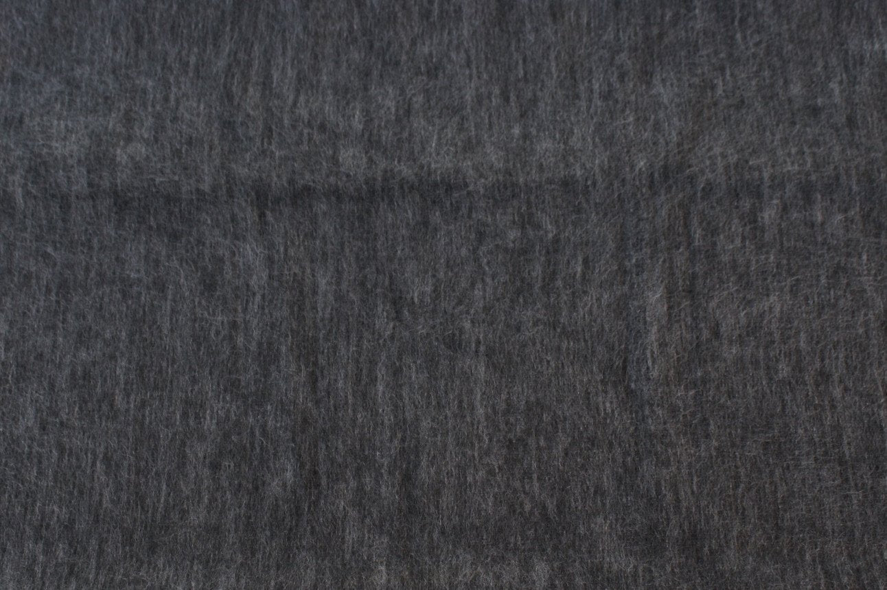 Luxurious alpaca bed blanket in various colors, showcasing its soft texture and oversized design, perfect for cozy nights.