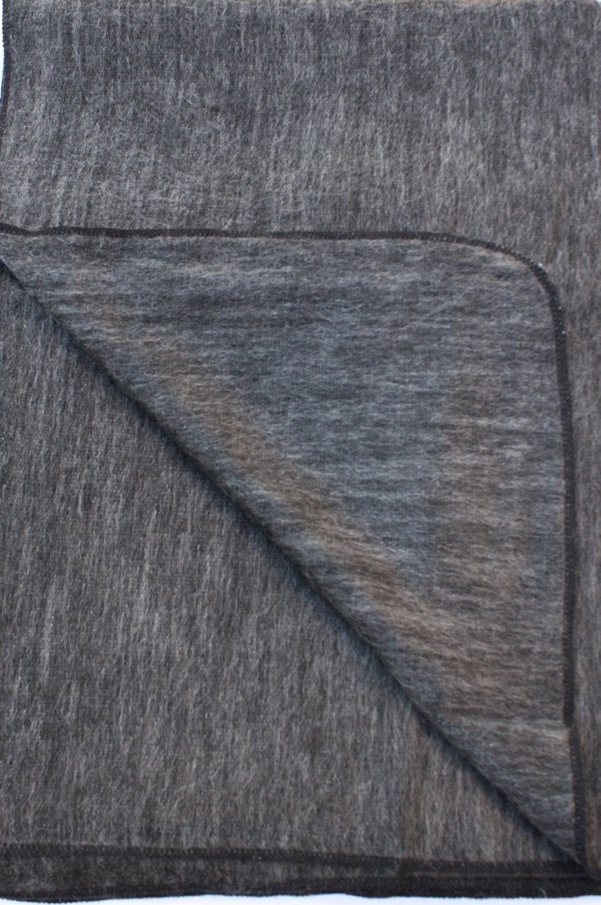 Luxurious alpaca bed blanket in various colors, showcasing its soft texture and oversized design, perfect for cozy nights.