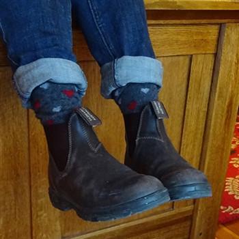 Cozy Alpaca Heart Socks in graphite grey with red and light grey heart patterns, showcasing their soft texture and unisex design.